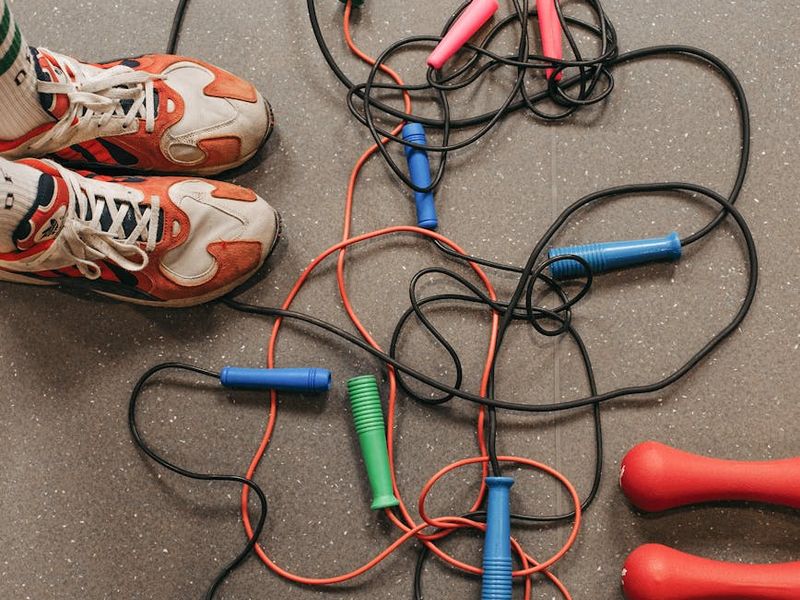 Detailed view of fitness equipment and sneakers on floor.